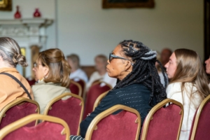 A lady listening to a presentaion